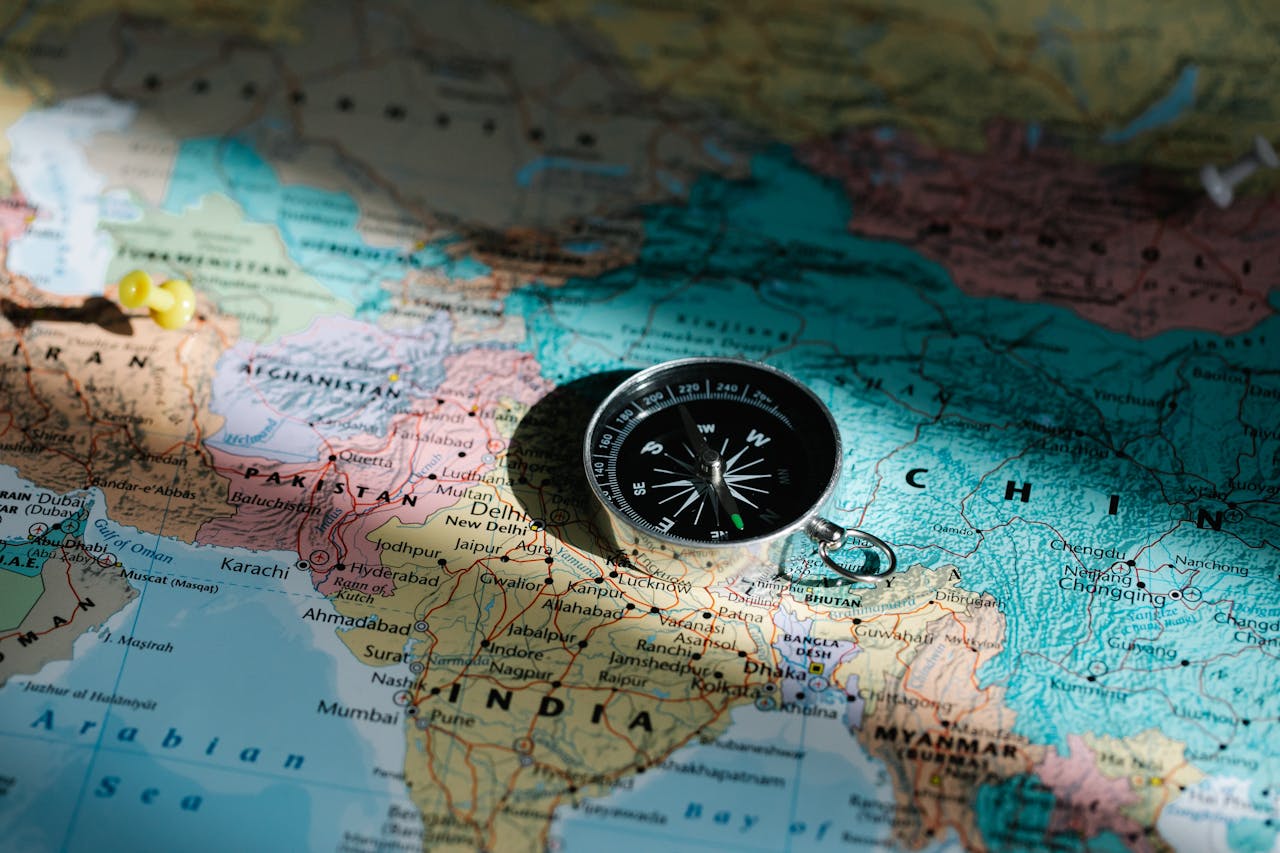 services-04 Close-up image of compass on a world map highlighting travel direction and exploration.